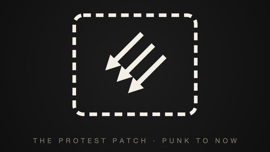 A stitched rectangular patch carrying three downward arrows — the protest patch, punk to now