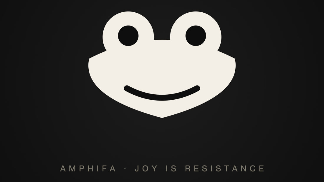 A round cartoon frog face — the Portland frog, mascot of absurdist nonviolent protest
